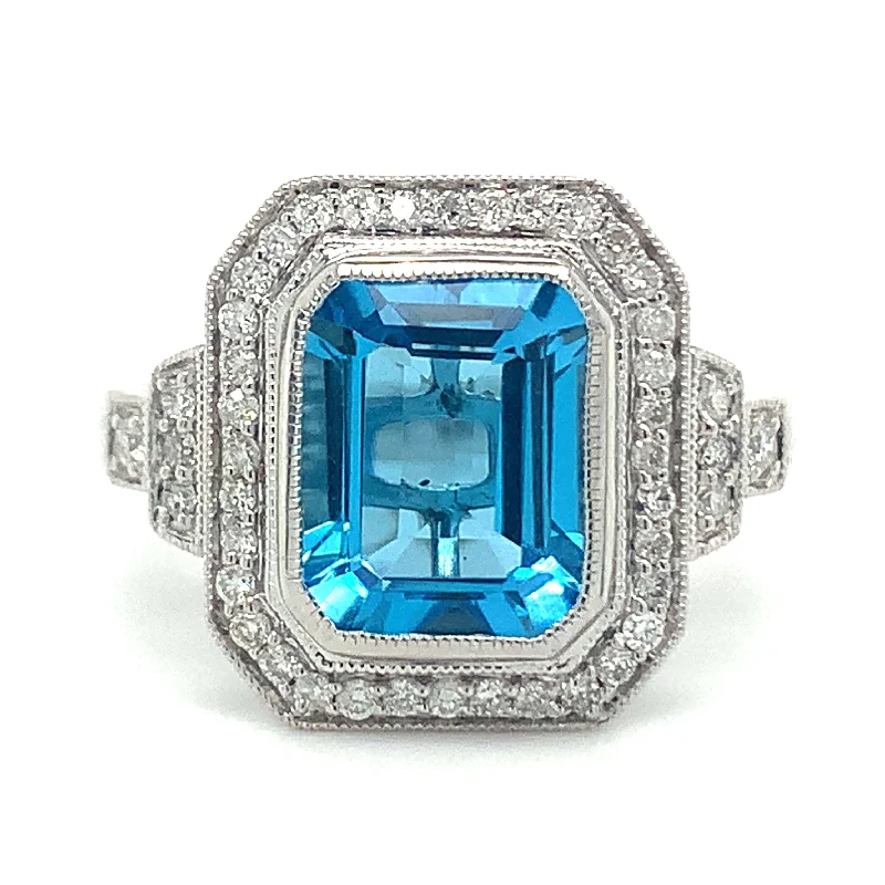 9ct White Gold 4.18ct Emerald Cut Blue Topaz and Diamond Pave Set Halo