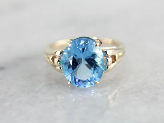 Brilliant Blue Topaz, Accented Split Shank Solitaire Ring in Yellow Gold